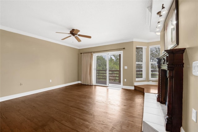 unfurnished living room with baseboards, wood finished floors, a ceiling fan, and crown molding