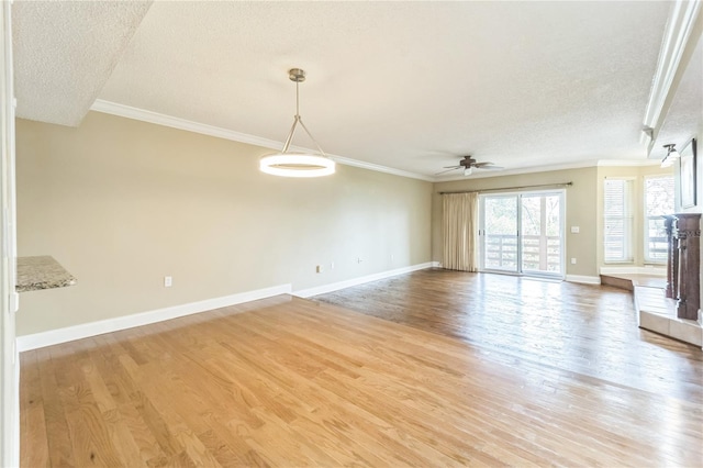 unfurnished living room featuring ornamental molding and light wood-style floors