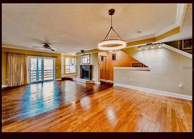 1710 Lighthouse Ter S Unit 1, South Pasadena, FL 33707 - unfurnished living room with a textured ceiling, crown molding, baseboards, and ceiling fan
