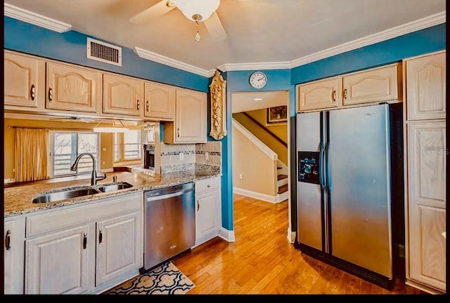 1710 Lighthouse Ter S Unit 1, South Pasadena, FL 33707 - kitchen with crown molding, a sink, light wood finished floors, appliances with stainless steel finishes, and visible vents