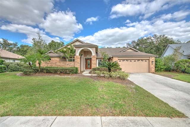 view of front of property featuring a front yard and a garage