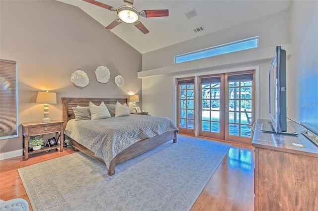 bedroom featuring high vaulted ceiling, french doors, hardwood / wood-style flooring, ceiling fan, and access to exterior