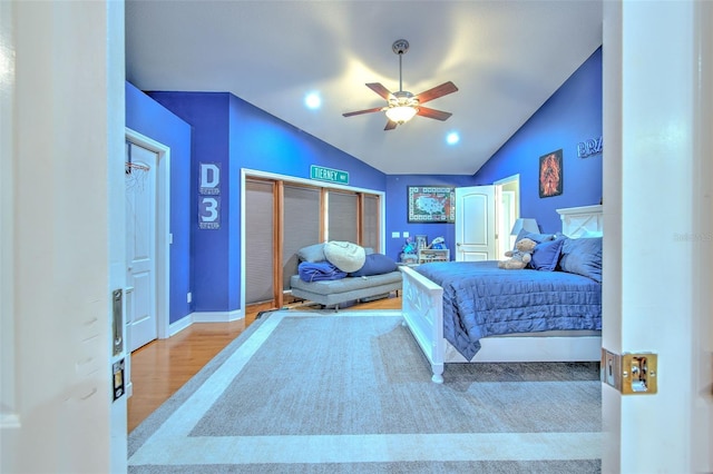 bedroom with light hardwood / wood-style flooring, ceiling fan, and lofted ceiling