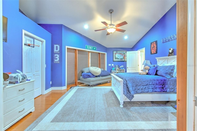 bedroom featuring light hardwood / wood-style floors, ceiling fan, and lofted ceiling