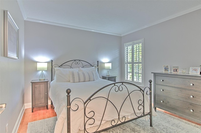 bedroom with crown molding and light hardwood / wood-style flooring