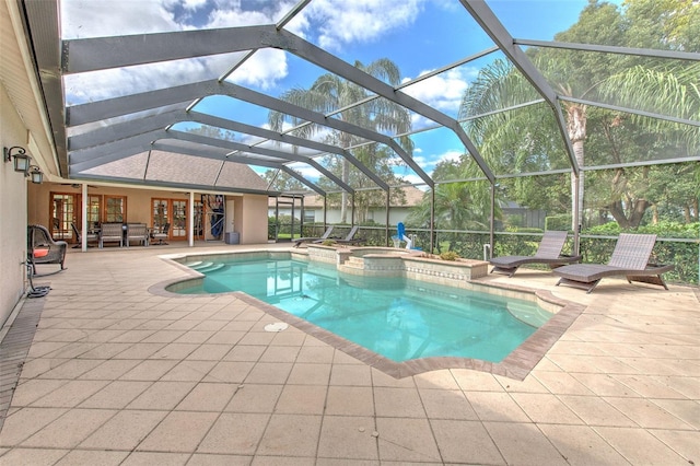 view of swimming pool featuring glass enclosure, an in ground hot tub, and a patio