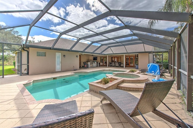 view of pool with an in ground hot tub, a patio, and glass enclosure