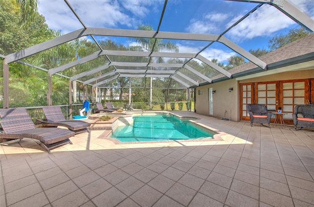 view of swimming pool featuring a patio and a lanai