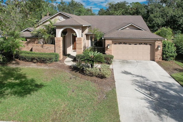 view of front of house featuring a garage and a front lawn