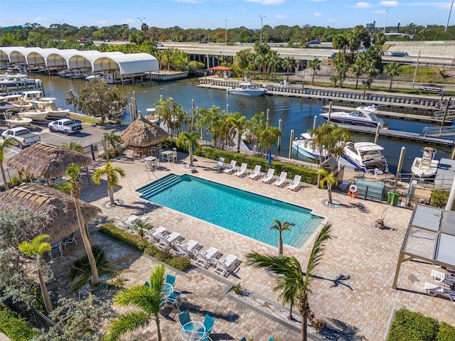 view of pool featuring a water view and a patio area