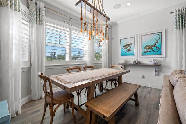 dining area featuring wood-type flooring and ornamental molding