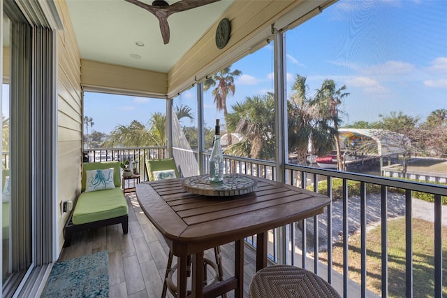 sunroom with a wealth of natural light and ceiling fan