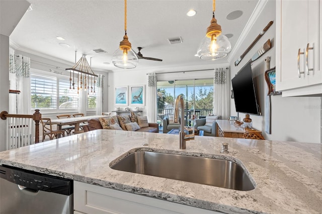 kitchen featuring dishwasher, pendant lighting, white cabinetry, and crown molding