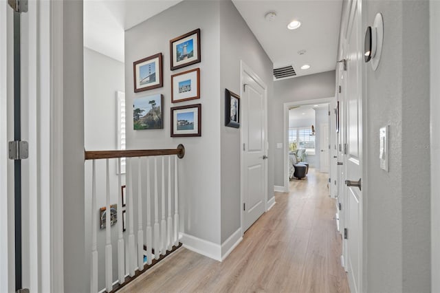 hall with light hardwood / wood-style flooring