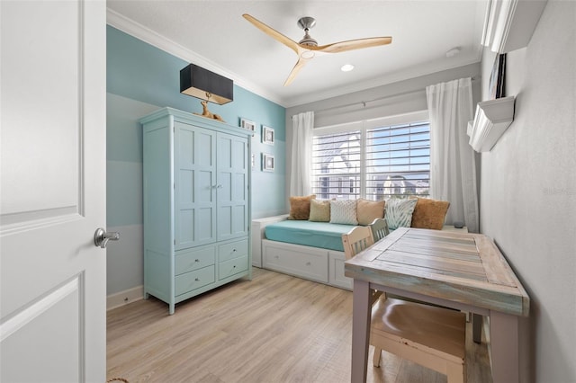 bedroom with ceiling fan, light hardwood / wood-style floors, and crown molding