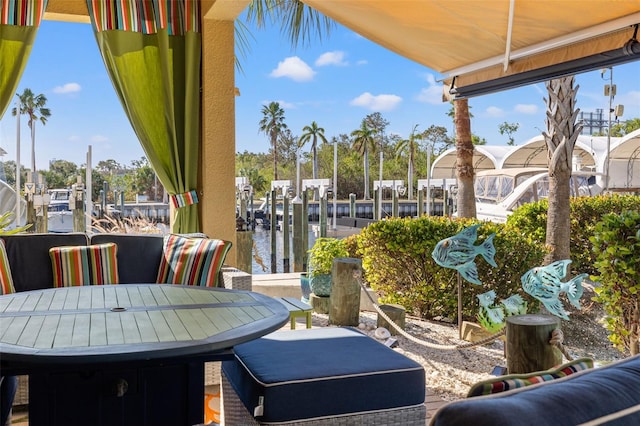 view of patio featuring a water view and a boat dock