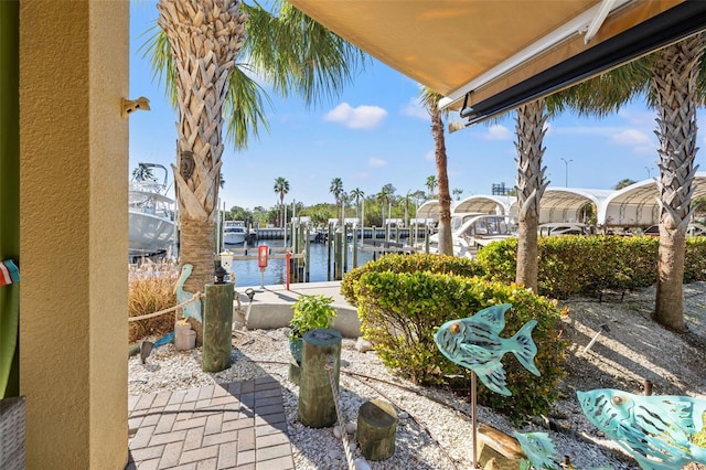 view of patio / terrace featuring a water view and a boat dock