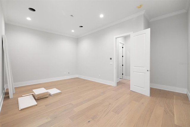 unfurnished room with light wood-type flooring and crown molding