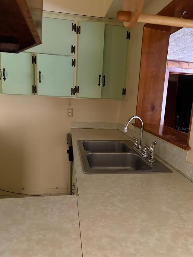 kitchen with sink and green cabinetry