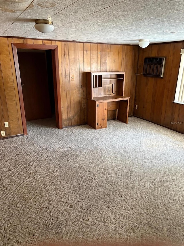 interior space featuring carpet and wooden walls