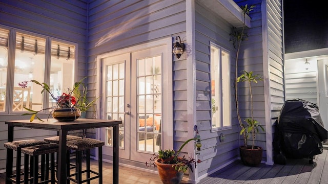 exterior space featuring french doors, hardwood / wood-style flooring, and wooden walls