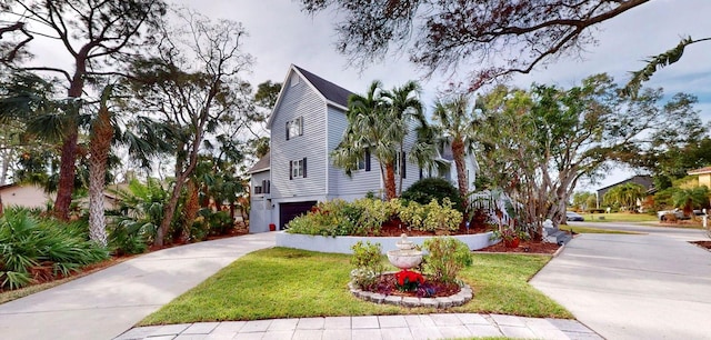 view of front of home with a front yard and a garage