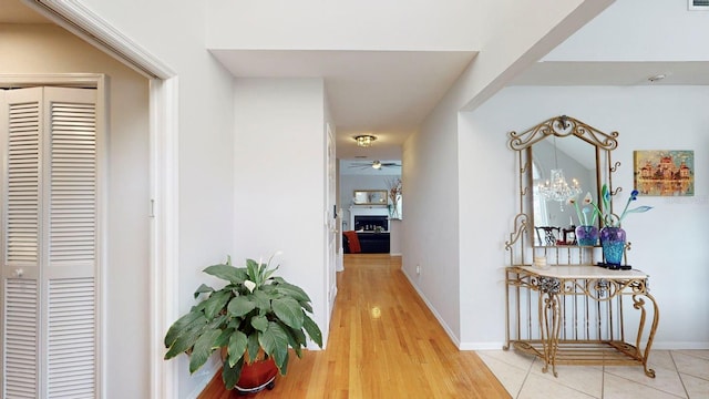 hallway featuring hardwood / wood-style floors and a notable chandelier