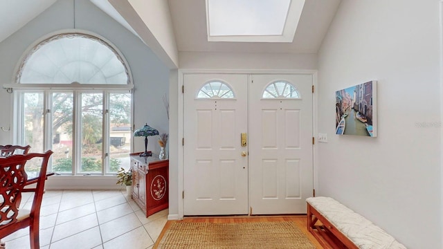 tiled foyer with lofted ceiling