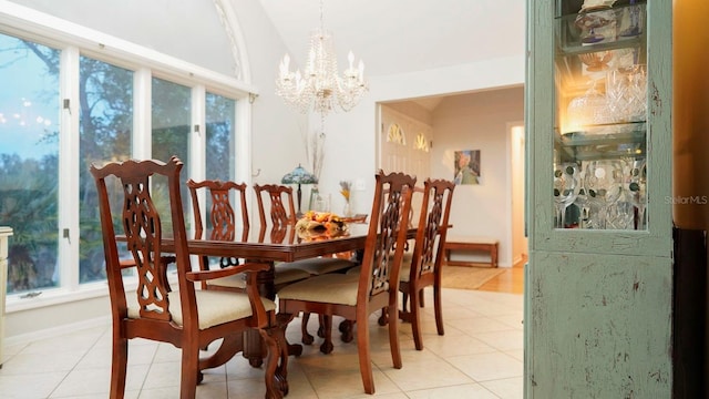 tiled dining area featuring a chandelier