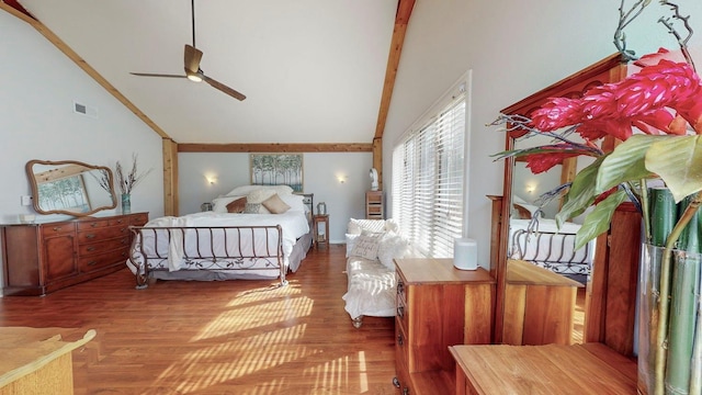 bedroom with beamed ceiling, hardwood / wood-style floors, high vaulted ceiling, and ceiling fan