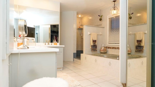 bathroom with plus walk in shower, vanity, and tile patterned floors