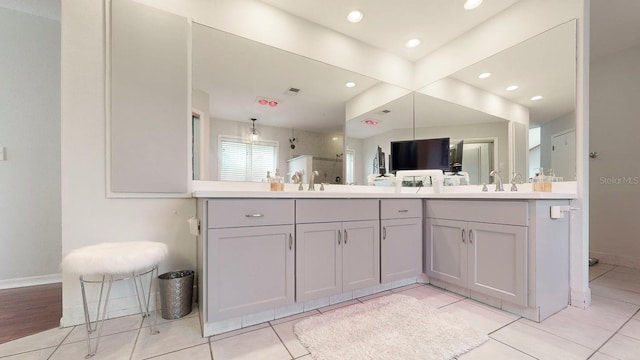 bathroom featuring tile patterned flooring, vanity, and an enclosed shower