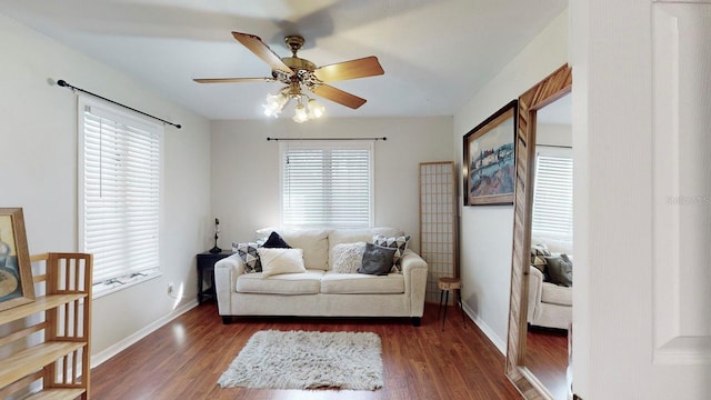 living room with dark hardwood / wood-style flooring, plenty of natural light, and ceiling fan