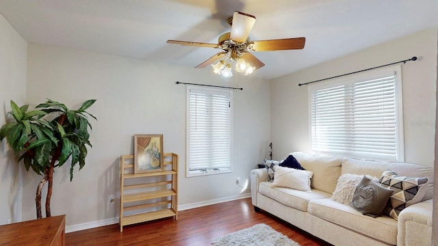 living room with dark hardwood / wood-style floors, ceiling fan, and a healthy amount of sunlight