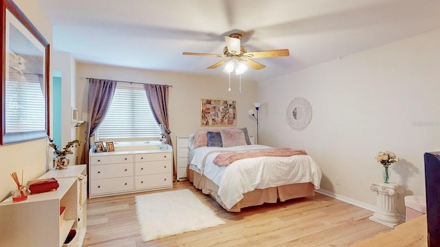 bedroom with ceiling fan and light wood-type flooring