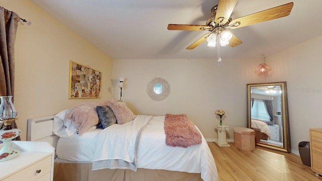 bedroom with light hardwood / wood-style floors and ceiling fan