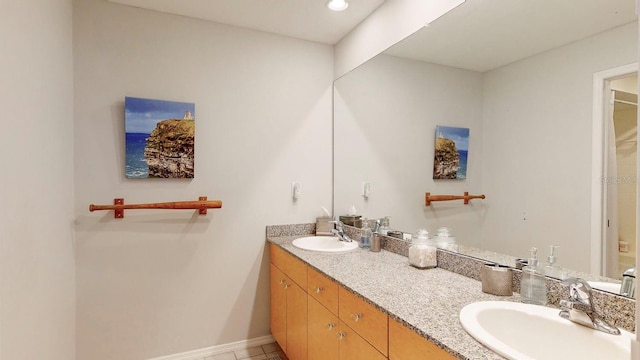 bathroom featuring tile patterned flooring and vanity