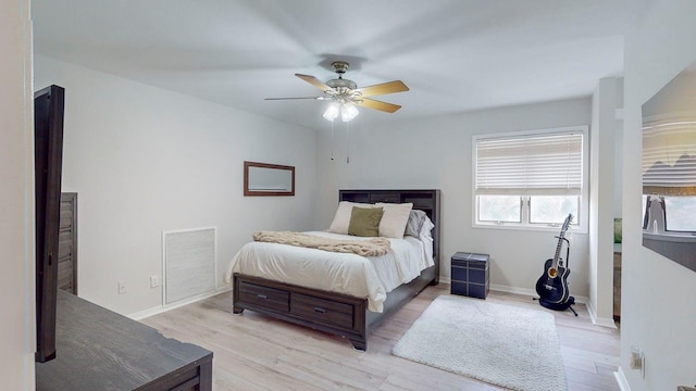 bedroom with light hardwood / wood-style flooring and ceiling fan