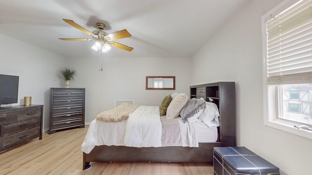 bedroom with light wood-type flooring, ceiling fan, and lofted ceiling