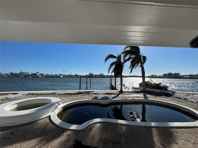 exterior space with a water view and a dock