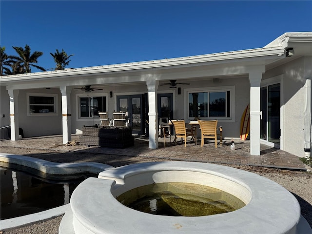 back of property with a patio area and ceiling fan