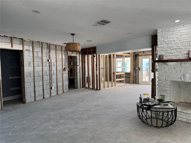 basement featuring a fireplace and a textured ceiling