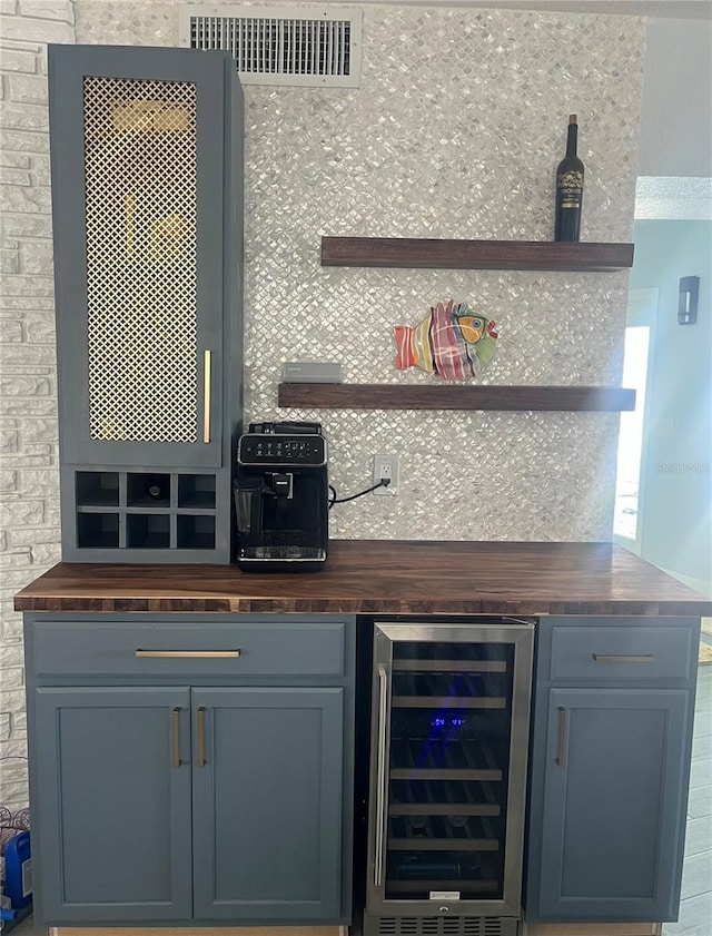 bar with a bar, wine cooler, and visible vents