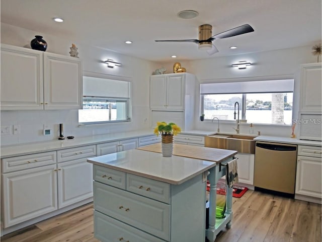 kitchen featuring light countertops, white cabinets, and stainless steel dishwasher