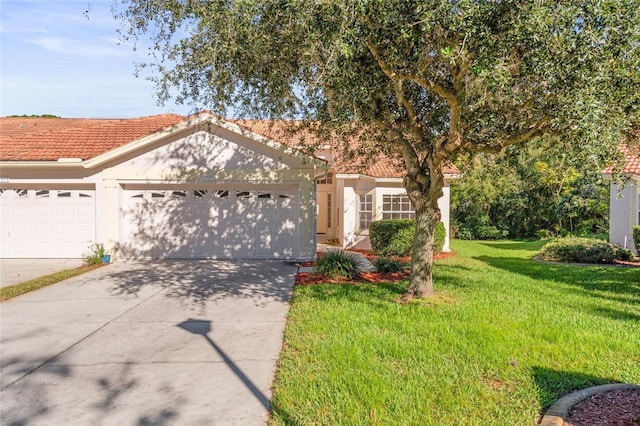 view of front of home with a front yard and a garage