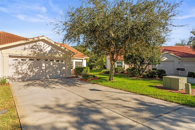 view of front of house with a garage and a front lawn