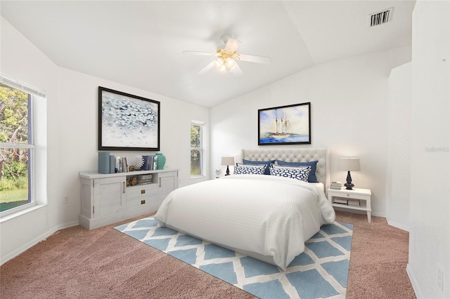 bedroom with ceiling fan, light carpet, and vaulted ceiling