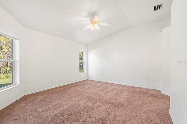 unfurnished room featuring ceiling fan, carpet floors, and vaulted ceiling