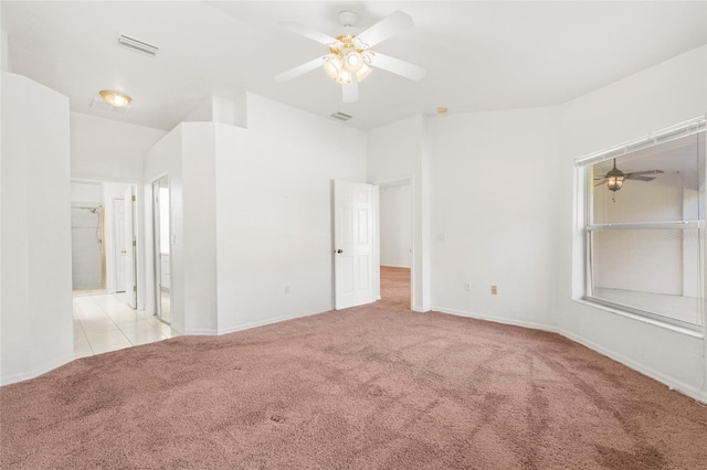 carpeted spare room featuring ceiling fan