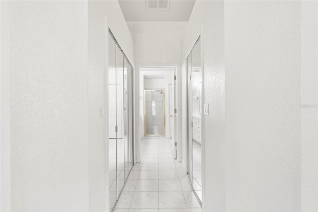 hallway featuring light tile patterned floors